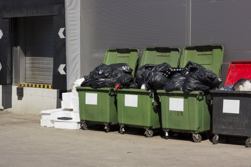 Commercial waste collection trucks in West London